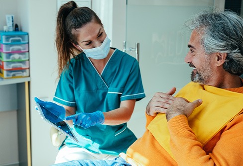 Patient in Rocky River reviewing dental implant post-op instructions with dental team