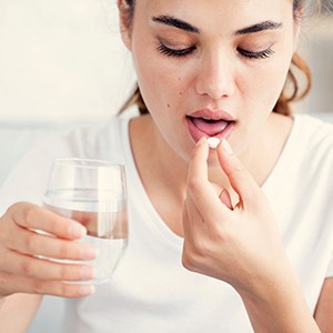 Woman taking a pill