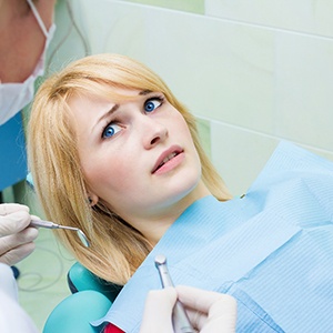 Woman afraid in the dental chair